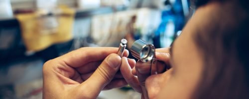 Different goldsmiths tools on the jewelry workplace. Jeweler at work in jewelry. Desktop for craft jewelry making with professional tools. Close up view of tools.